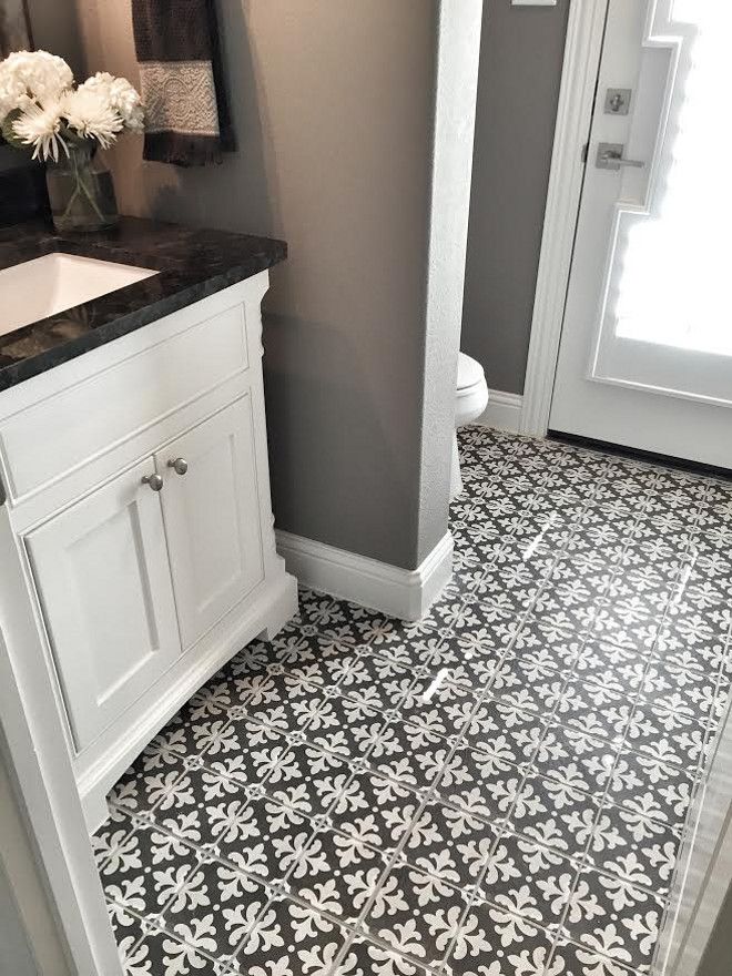 gray wall in bathroom with black white tile