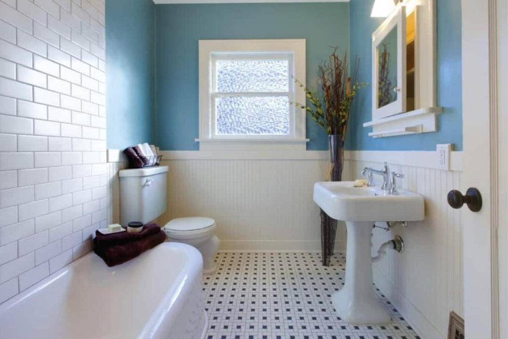 light blue bathroom walls and white and black floor tiles