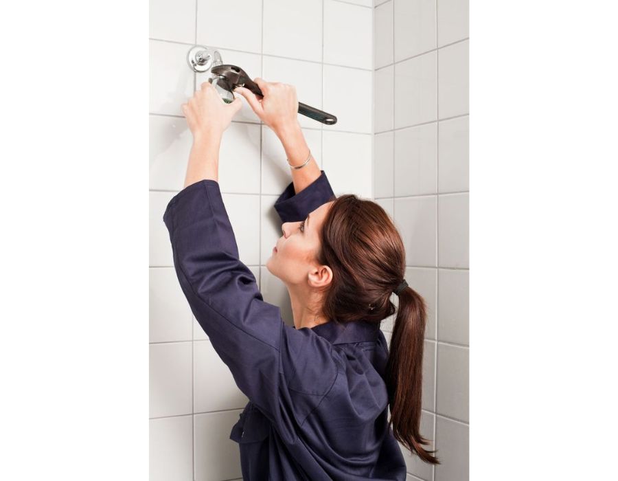professional conducting shower repair
