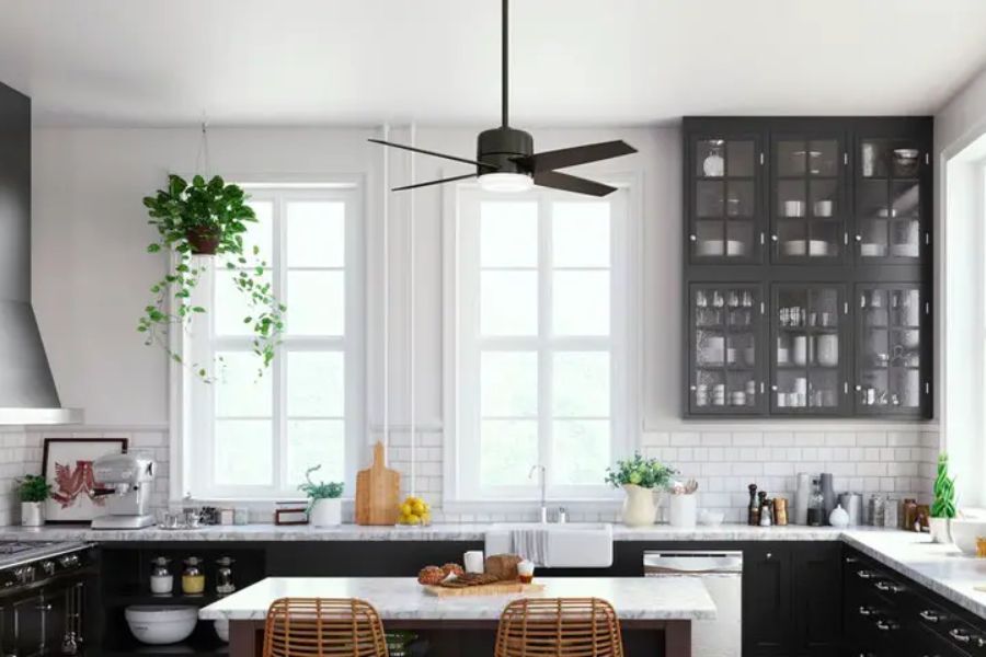 modern kitchen with black cabinets and ceiling fan