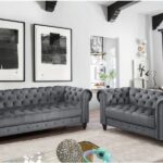 light gray wall with dark gray tufted furniture