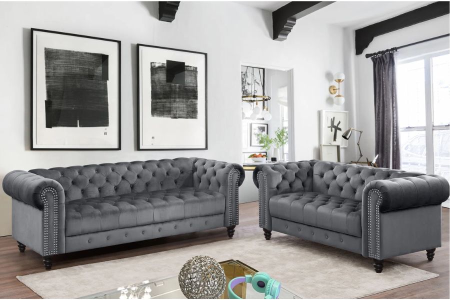 light gray wall with dark gray tufted furniture