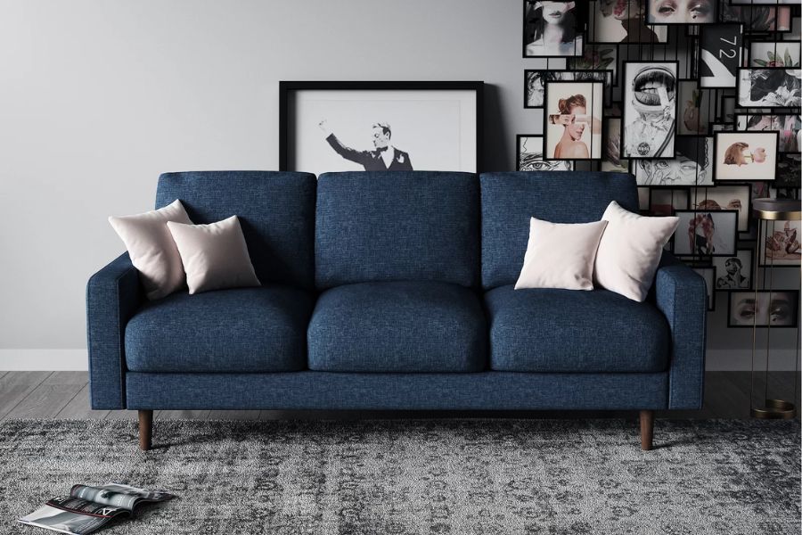 light gray wall contrasted with navy blue sofa